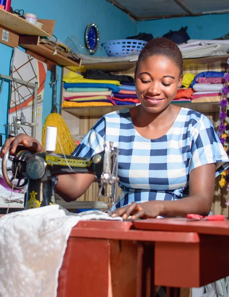 Sartorial woman entrepreneur using a sewing machine